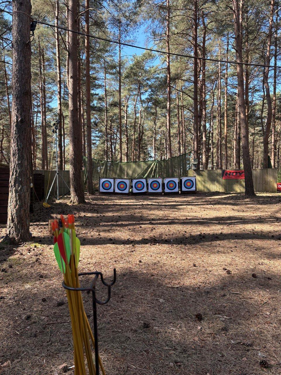 The woodland archery range at Leisure Matters, with six targets set across a clearing in the pines