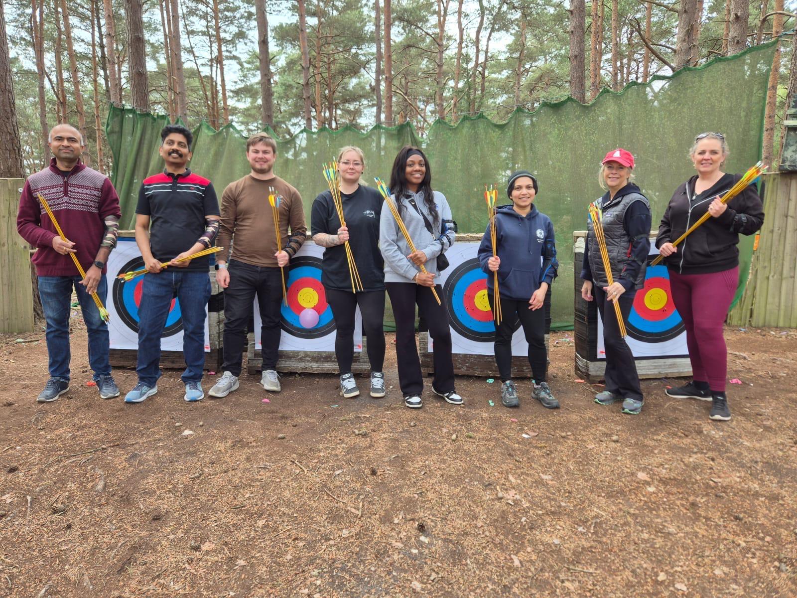 Group of archers shooting together on the woodland range