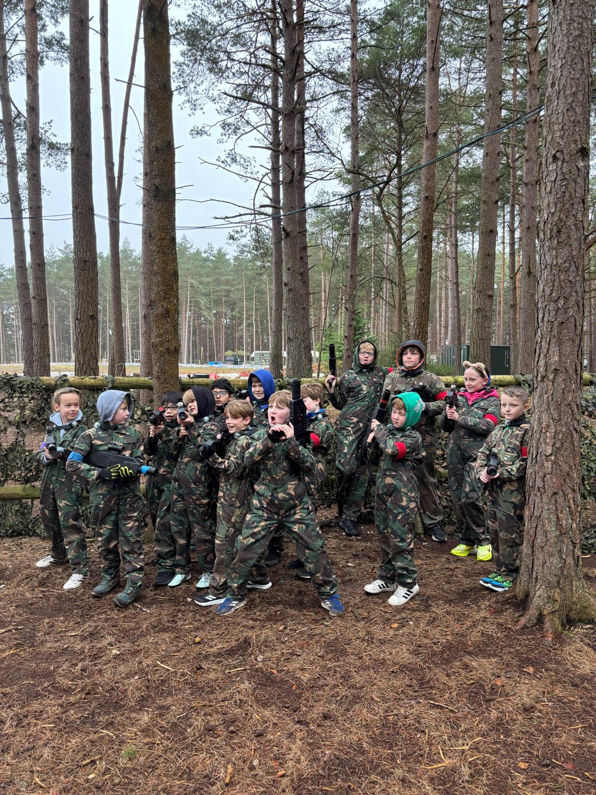 Group of players lined up in the woodland arena before a game