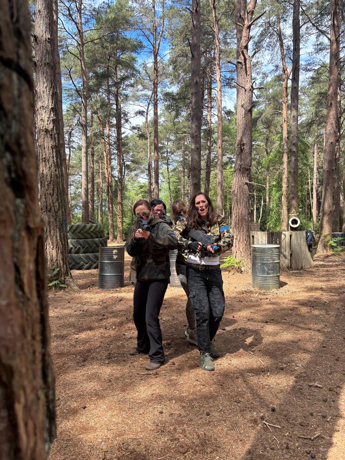 Player taking cover behind a woodland barricade during a Hyper Shock game