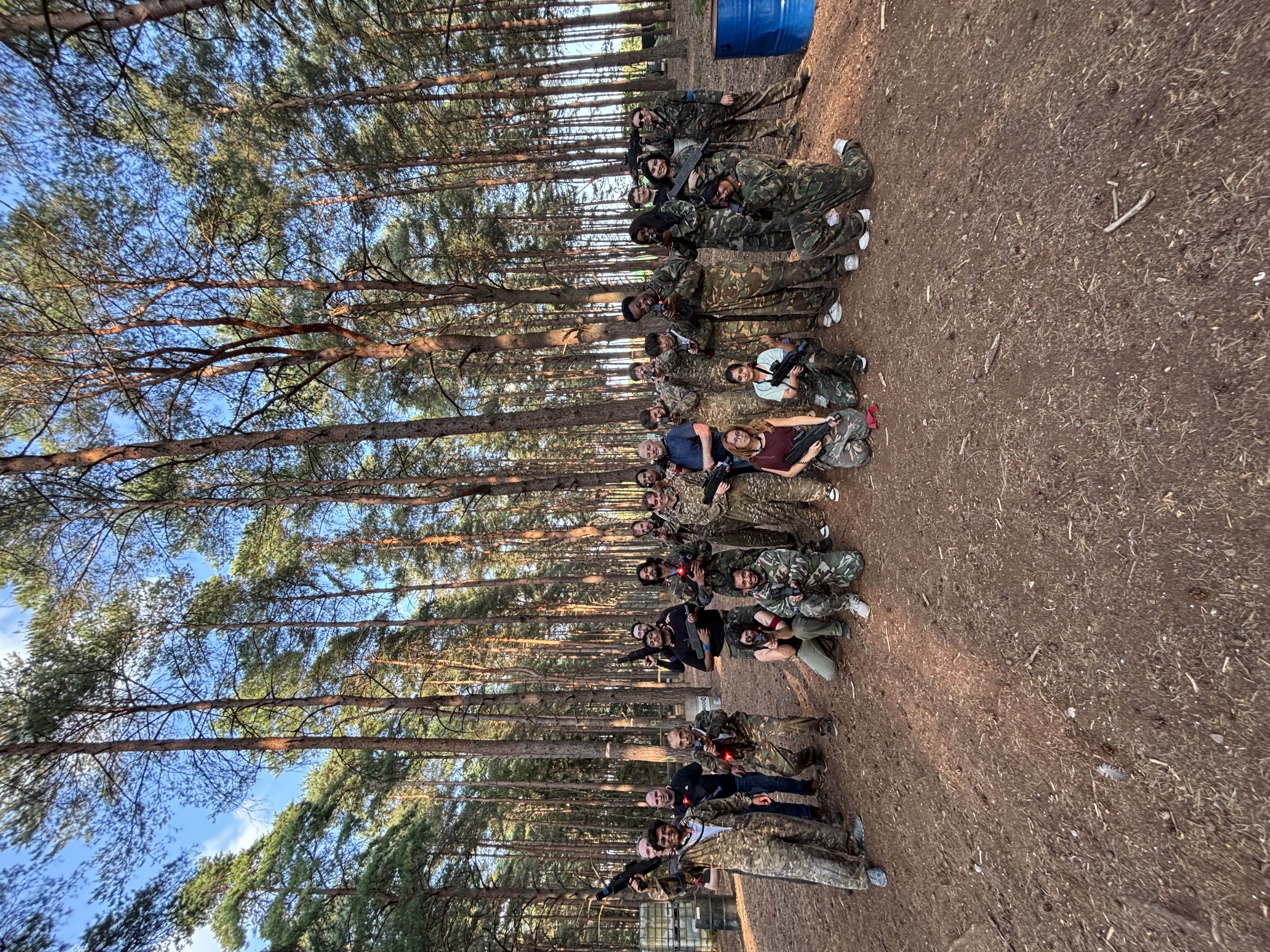 Adults taking part in a laser tag session in the woodland arena