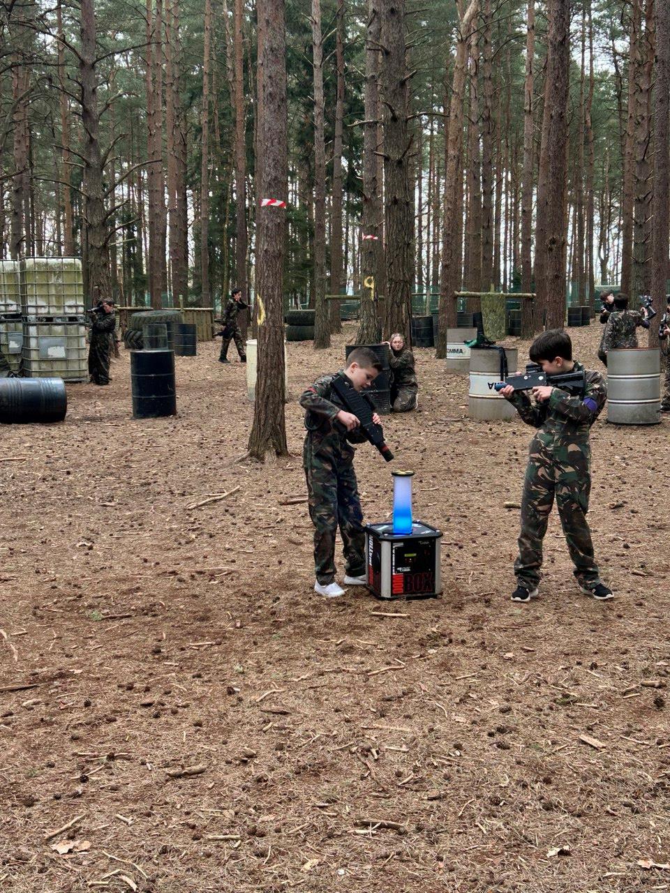 Player crouched behind woodland cover during a laser tag mission