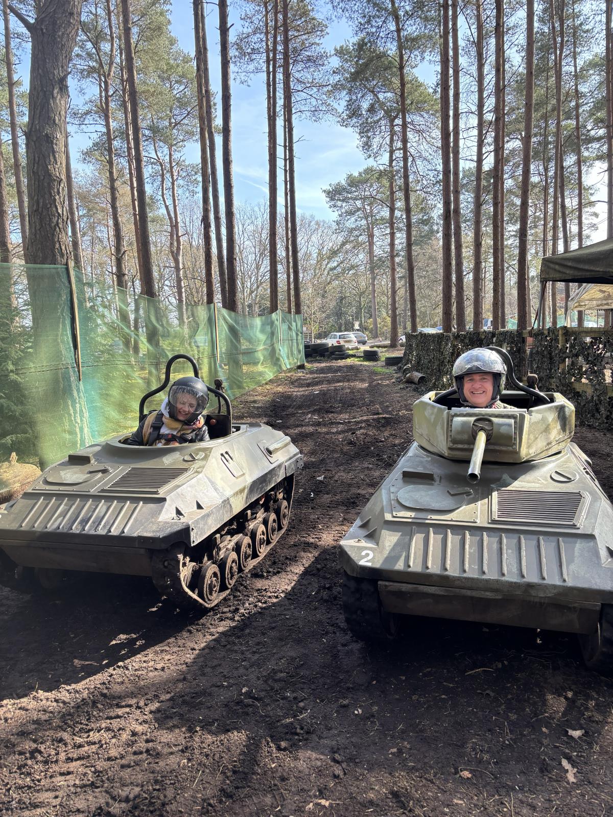 Two mini tanks with drivers on the woodland course, part of the laser tag and mini tank combo
